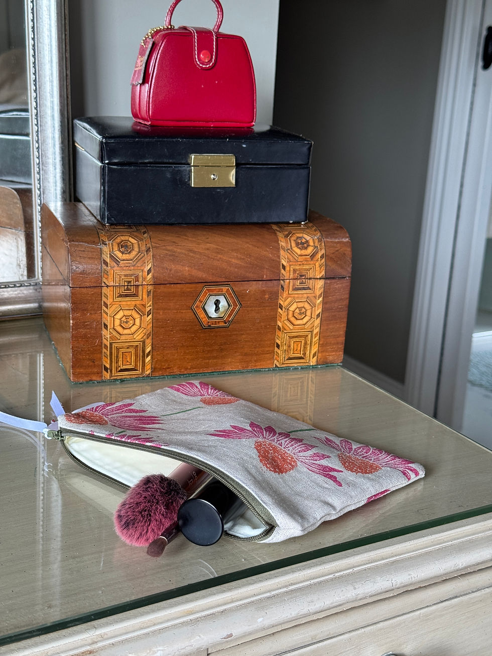 Thumbnail: glass top with makeup bag and wooden box