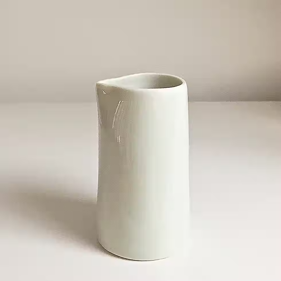 white porcelain pourer jug on white background
