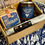 Thumbnail: box containing bag with blue label, jar with blue label and long white wrapped meat with black label