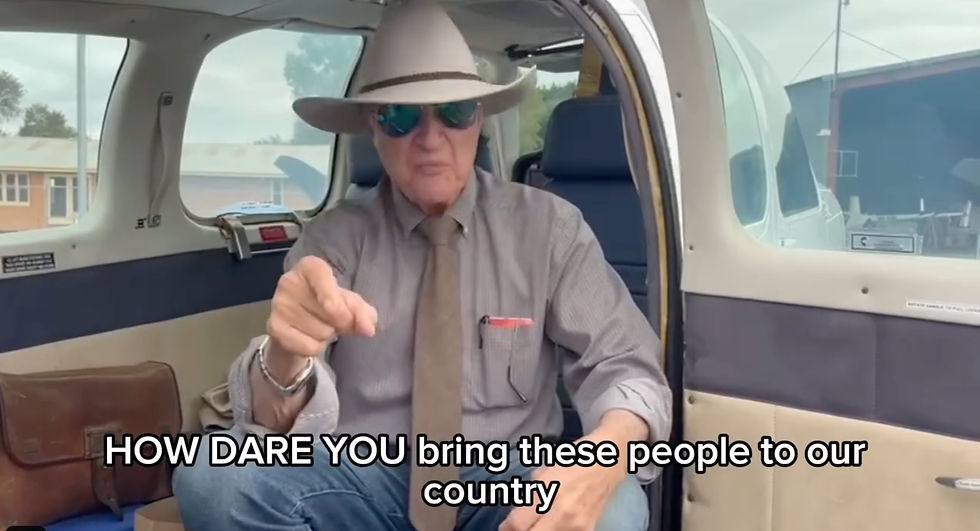 a man sitting in a car and pointing