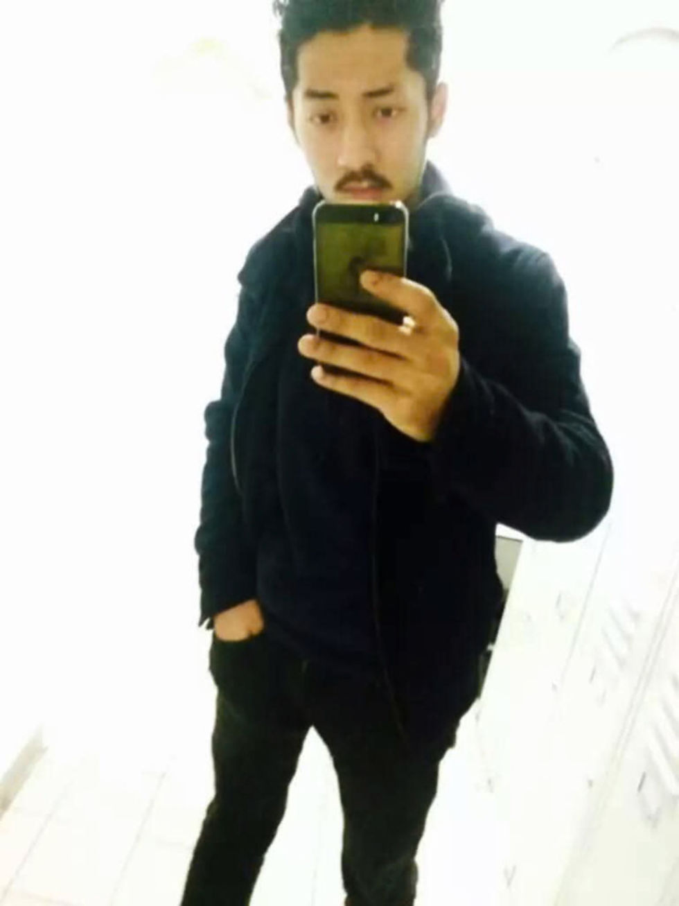 man in black shirt with phone