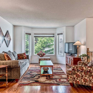 Photo-ready staging in Maple Ridge, Airdrie using homeowner furnishings to create a bright and welcoming living room.