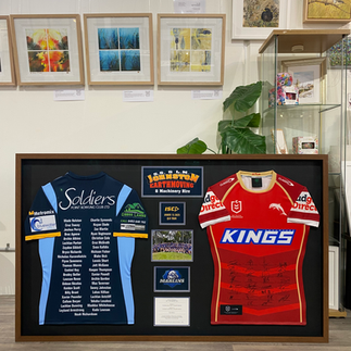 custom framing of two jerseys with logo and photo and plaque