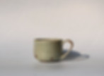 Handcrafted pottery cup made from clay, featuring a unique, ocean like glaze.