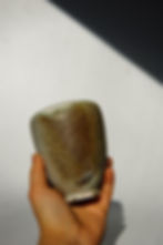 Handcrafted pottery cup made from clay, featuring a unique, ocean like glaze.