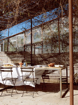 An outdoor seating area with a white tablecloth