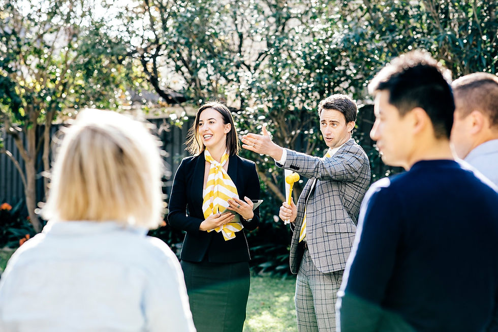 Auctioneer and crowds of buyers at Ray White Auction