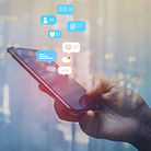 marketer-holding-phone-while-trying-to-increase-social-media-engagement.jpg