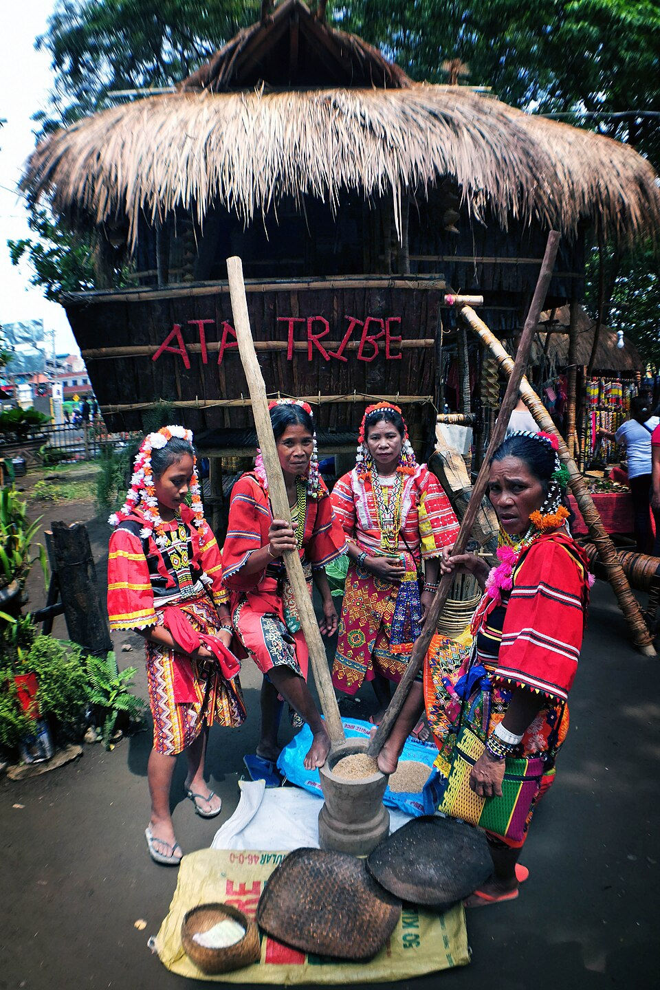 Members of the ATA Tribe in the Philippines mill rice.