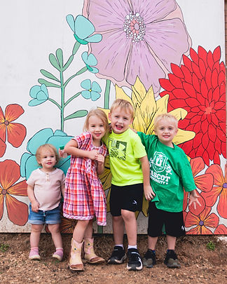 Family in front on=f mural
