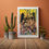 Thumbnail: Framed OOAK 13x19" ROC Skyline print on floor next to large cactus and plants in rustic room.
