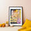 Thumbnail: Framed OOAK ROC Skyline art on light pink wall with yellow pillow and simple home decor items.