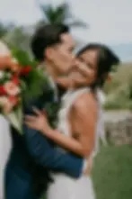 Groom kisses bride at their Wedding at Kualoa Ranch