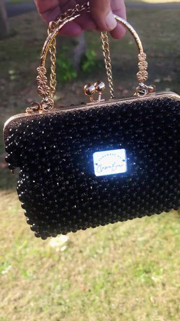 Video Of A Black Pearl Beaded Gold Kiss Lock Frame Handbag shown Outside with Grass In The Background