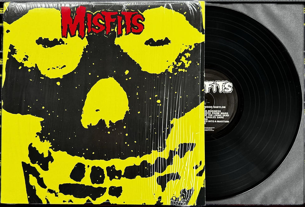 Front cover of The Misfits’ Collection I 2005 US repress, featuring the iconic yellow and black skull artwork with black vinyl partially visible