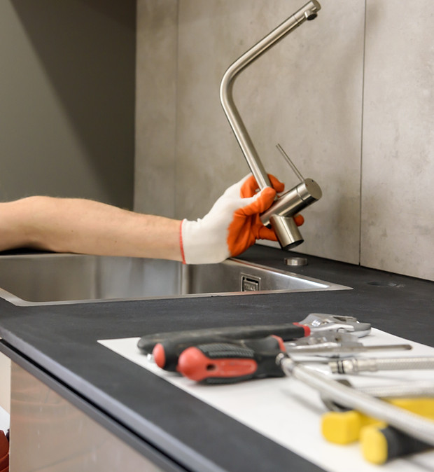 plumber-installing-faucet-kitchen-sink.jpg