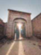 Cinematic storytelling of sunlight through ancient gates.