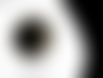 a white cup with black coffee in it