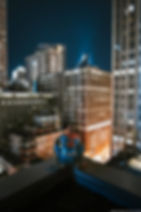 Spiderman on a rooftop overlooking the city