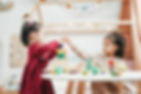 Girls playing with wooden blocks