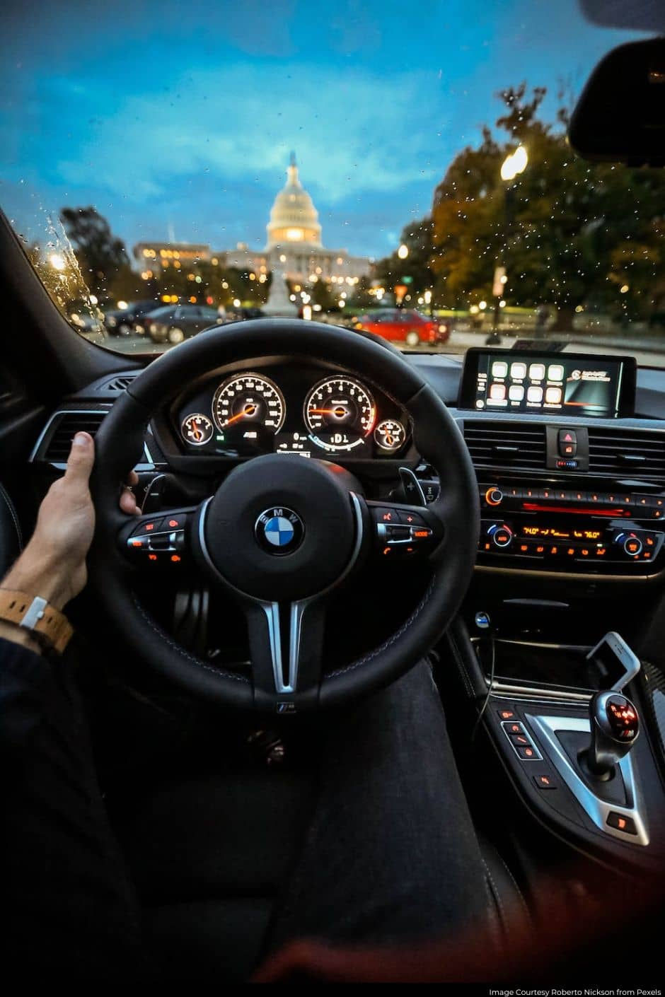 Person holding the steering wheel