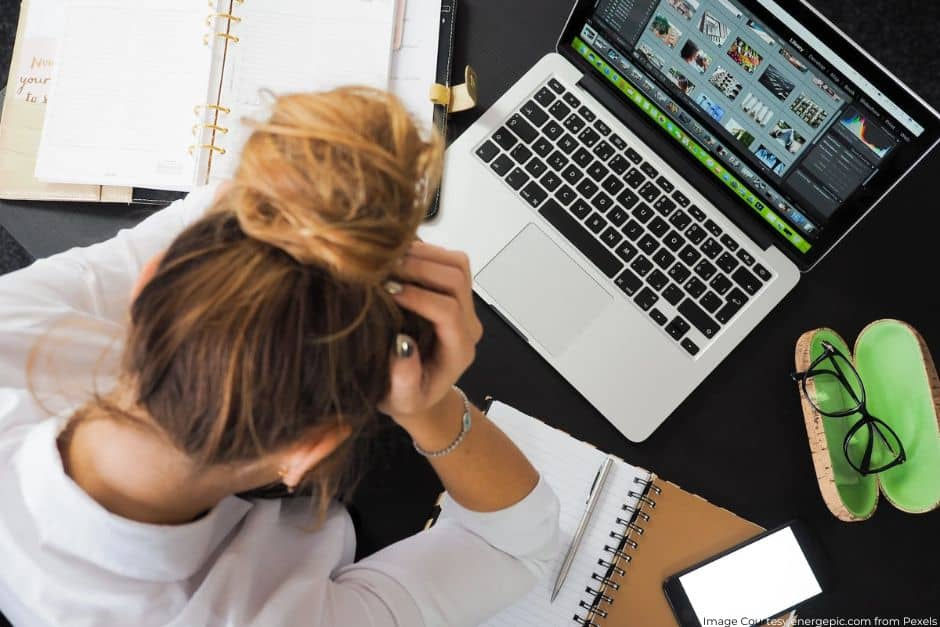 Woman stressing out in front of laptop