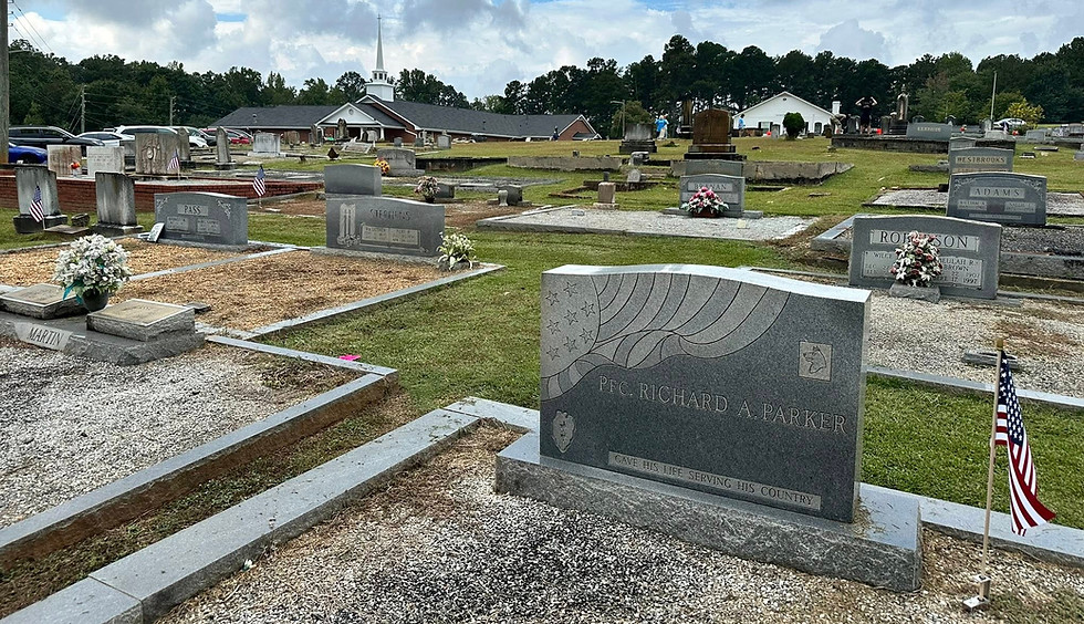 Headstones and family burial plots with Old Suwanee Baptist Church in background in Suwanee, Georgia.
