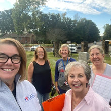 Five smiling women at the New Prospect UMC cemetery during a workday.