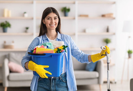 cheerful-young-housewife-holding-bucket-with-cleaning-supplies.jpg