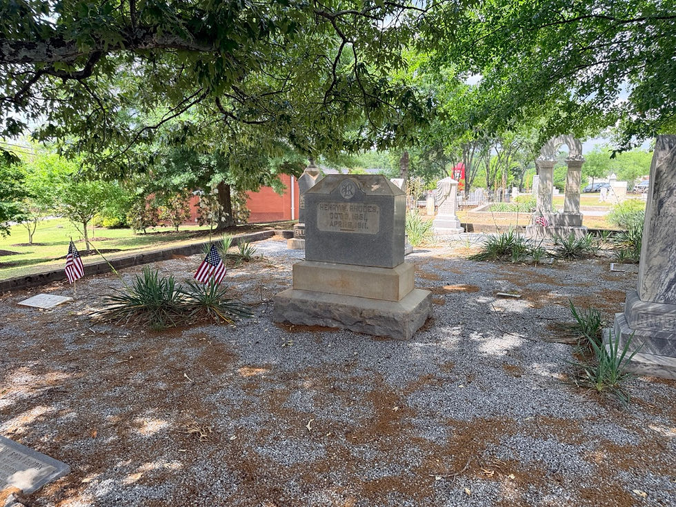 Historic cemetery memorial surounded by U.S. Flags, trees, and grave markers at Suwanee Town Cemetery in Suwanee, Georgia.