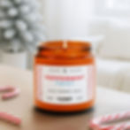 Lit Peppermint Twist candle with candy canes