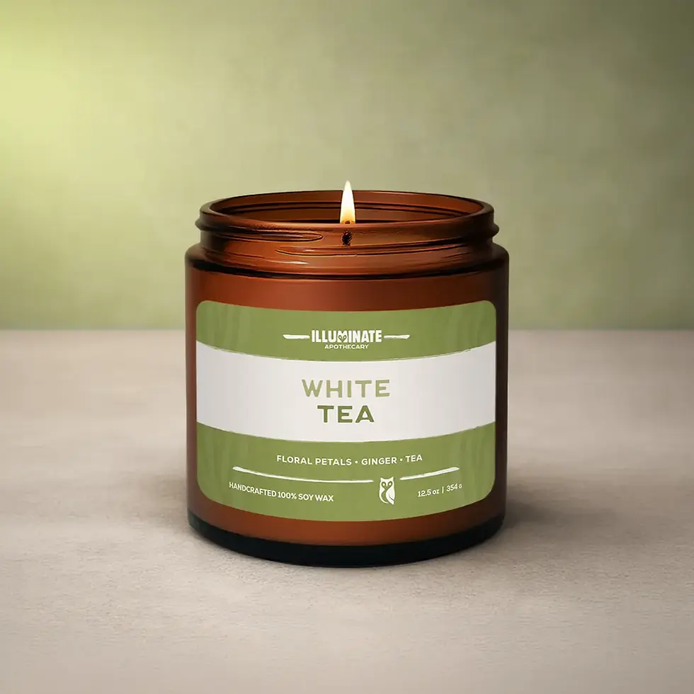 Thumbnail: Lit White Tea candle in amber jar