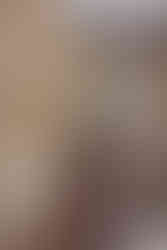 A property's living room with furniture and a large window captured by a photographer in London.