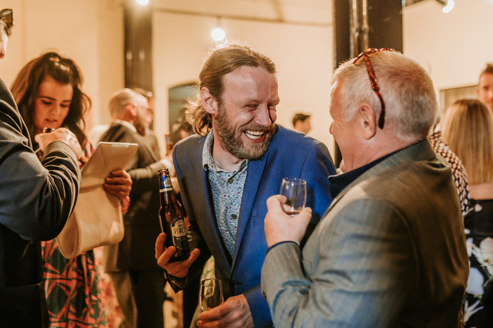 Guests laughing and interacting with other guests during drinks reception at Kelham Island Museum