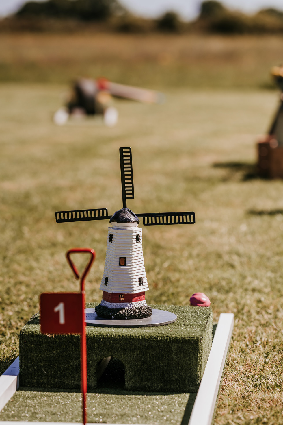 Windmill hole for garden mini golf garden games at converted barn wedding venue