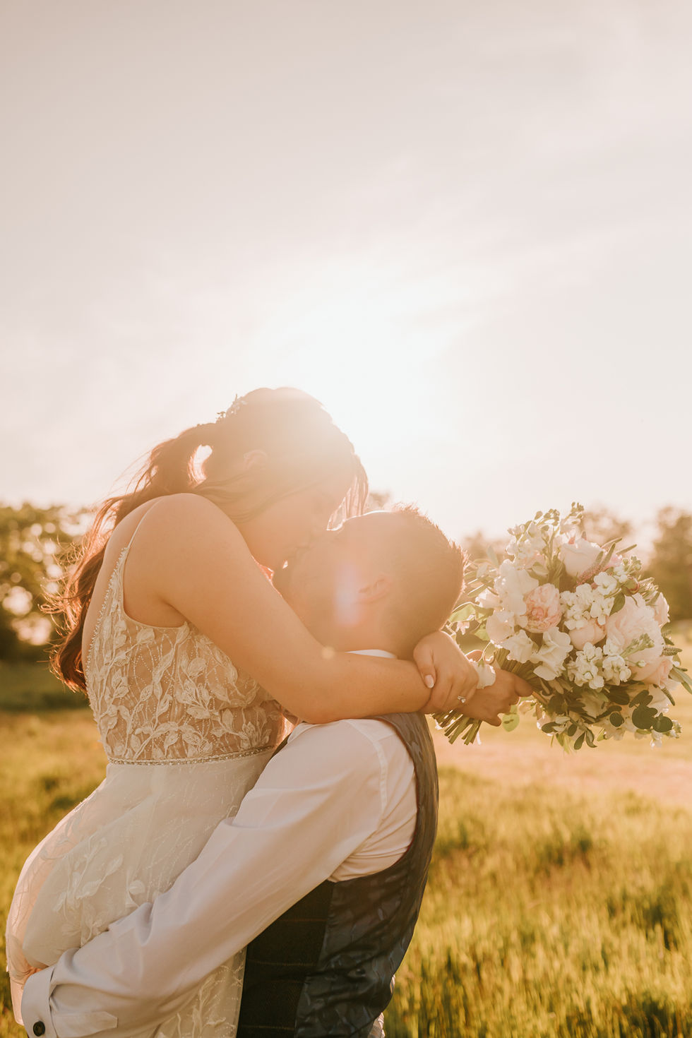 Bride and Groom kissing in the sun at Golden Hour Photoshoot