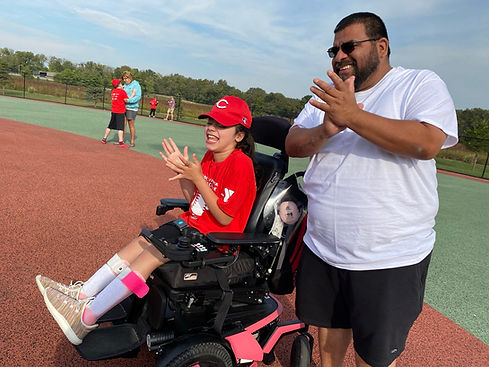 Player - Daughter in Wheelchair at 1st Base Clapping with Dad 2.JPEG