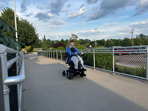 Player - Player in Wheelchair Coming Up Ramp Blue Skies and Clouds.JPEG