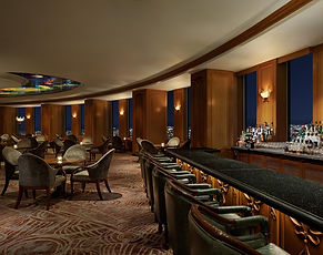 A sophisticated lounge offering stunning city views and an elevated atmosphere for fine cocktails and dining.