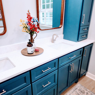 Remodeled bathroom with blue cabinets