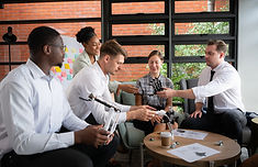 Group of diverse business professionals working together to solve challenges and develop organizational strategies.
