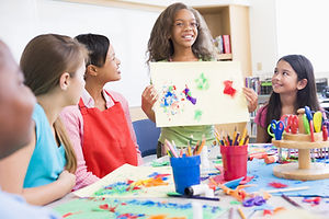 Elementary school pupil discussing picture with classmates.jpg