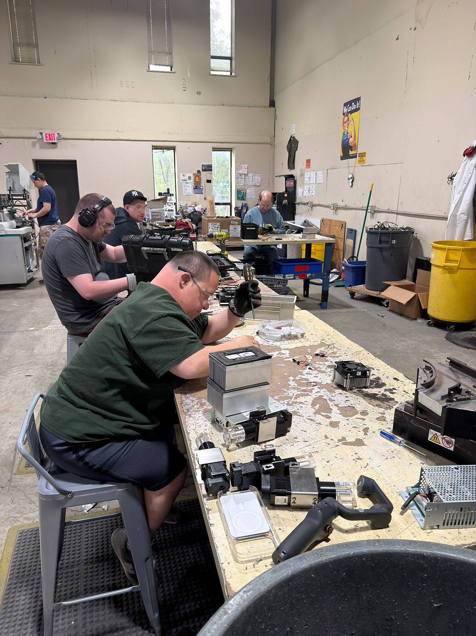 Adults in a day program assembling electronic components