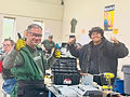 Men smiling during workforce development electronics recycling