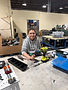 Woman disassembling electronics for e-waste drop off