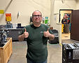 Man with glasses in green shirt giving thumbs up
