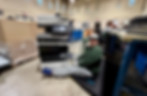 Man disassembling electronic device for recycling in New Jersey