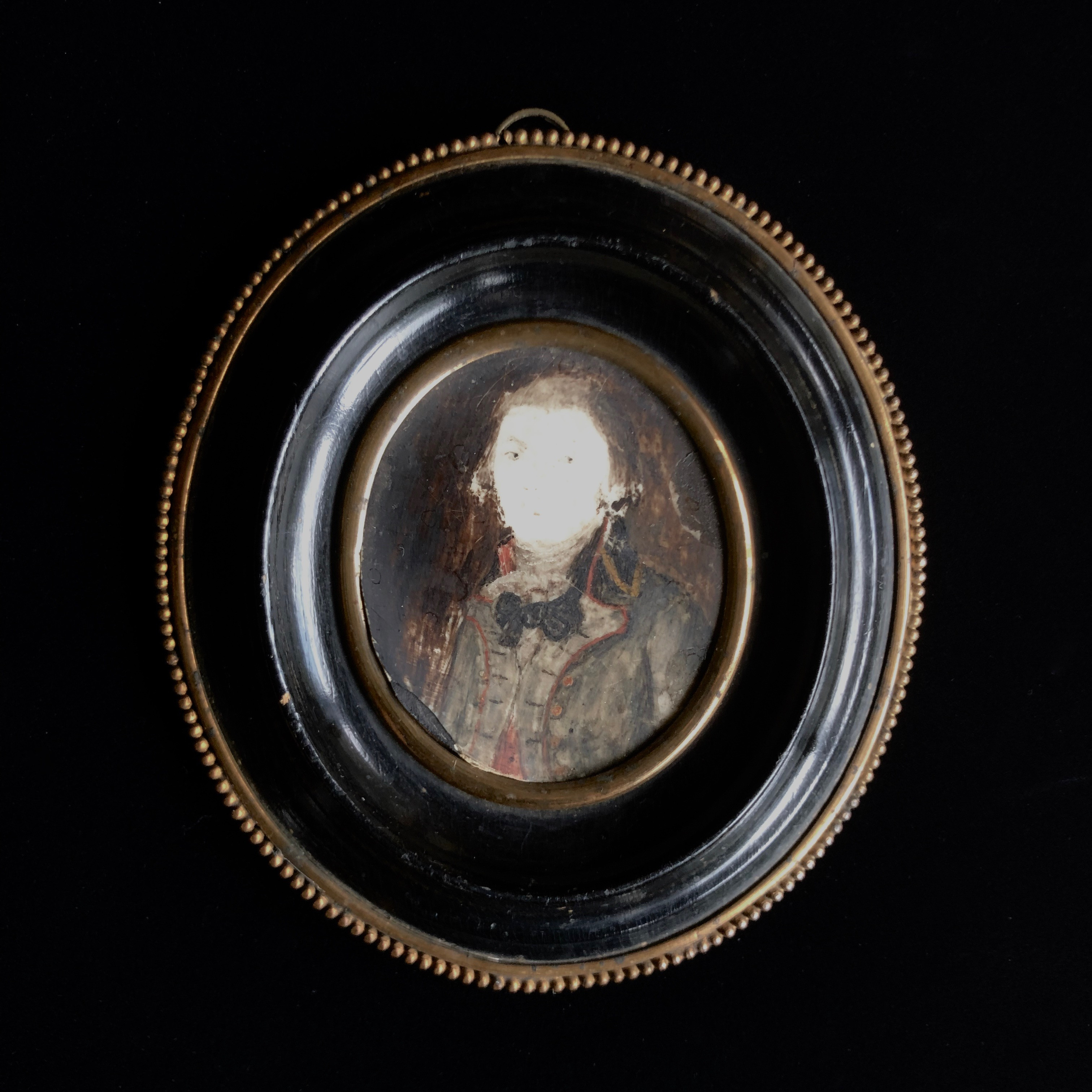 Black oval frame portrait