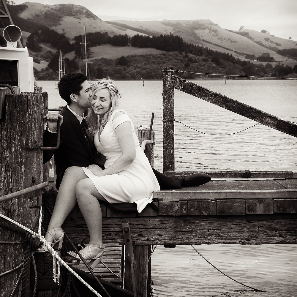 Bride and groom share a moment on their wedding day at Careys Bay, Dunedin