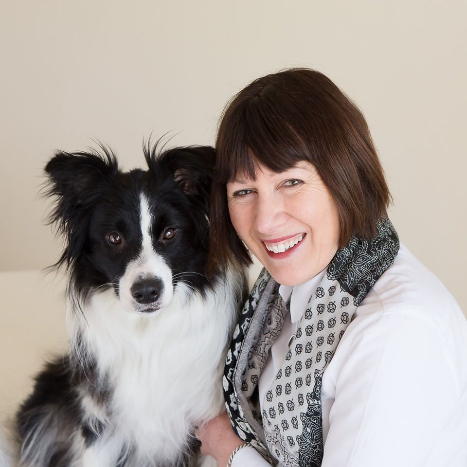 A Dunedin woman poses with her dog for her headshot